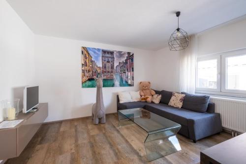 a living room with a blue couch and a teddy bear at Casa Merilana in Rust