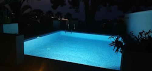 a large swimming pool at night with blue lights at Villa Coma in Denia