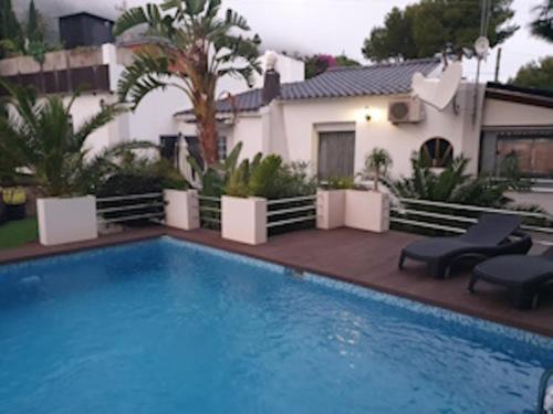 a large swimming pool in front of a house at Villa Coma in Denia