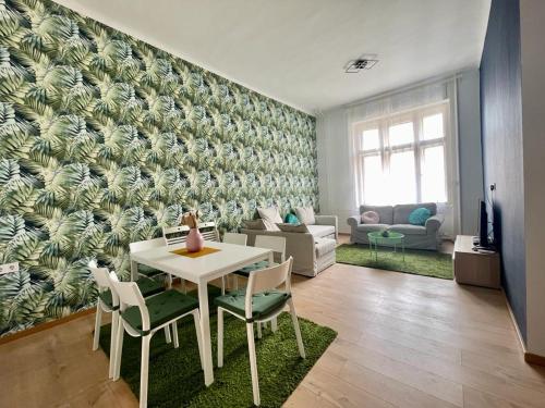 a living room with a table and chairs and a couch at Boutique HomeR1274 Apartment #3bedroom #freeparking in Budapest