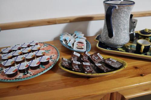 a counter with two plates of chocolate and a pitcher of coffee at B&B Zia Bianca in Vietri sul Mare
