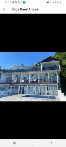 a picture of a building with a guest house at Goga Guest House in Kvariati