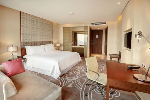 a hotel room with a bed and a desk at Crowne Plaza Dhaka Gulshan by IHG in Dhaka