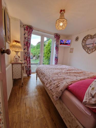 a bedroom with a bed and a window at Town Cottage ground floor appartment in Bridgend