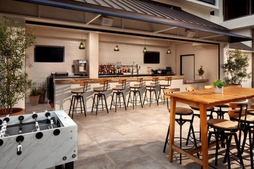 an outdoor bar with a table and bar stools at Sheraton Universal in Los Angeles