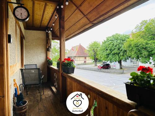 a balcony with a clock on the side of a building at Family M Apartments 15 in Kappel bei Olten