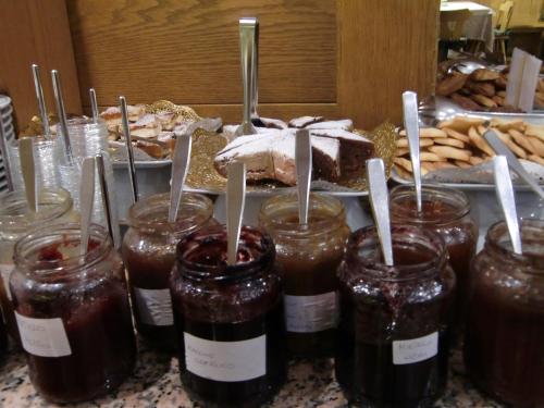 a group of jars of jam on a counter with food at Beauty & Vital Hotel Maria in Carano
