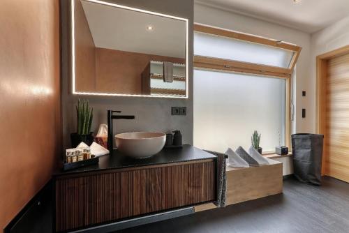 a bathroom with a sink and a large mirror at Chalet Romantik in Freyung