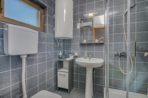 a small bathroom with a sink and a toilet at Apartment Moderna Soline in Dobrinj