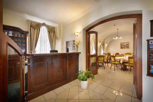 a living room with a wooden door and a dining room at Hotel Certovka in Prague