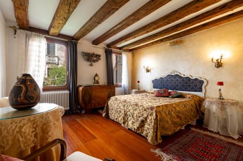 a bedroom with two beds and a large window at Ca' Mandorla 027042loc09523 in Venice