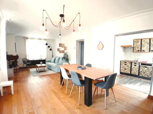 a dining room and living room with a table and chairs at VILLA CLARETTE in Carhaix-Plouguer