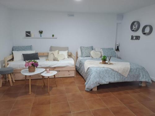 a living room with two beds and a couch at O Peteiro in Redondela