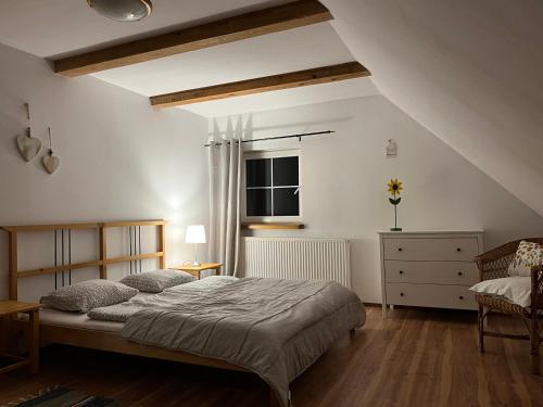 a bedroom with a large bed and a window at Dom na Mazurach in Ruciane-Nida