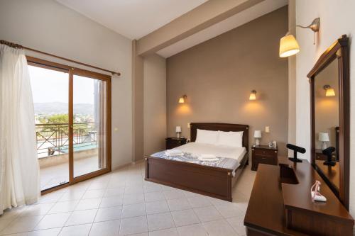 a bedroom with a bed and a large window at Villa Sofia in Anavyssos