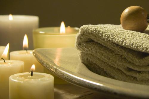 a pile of towels and candles on a mirror at Holiday Home Olea - Sun, Sea, Sport & Comfort in Splitska