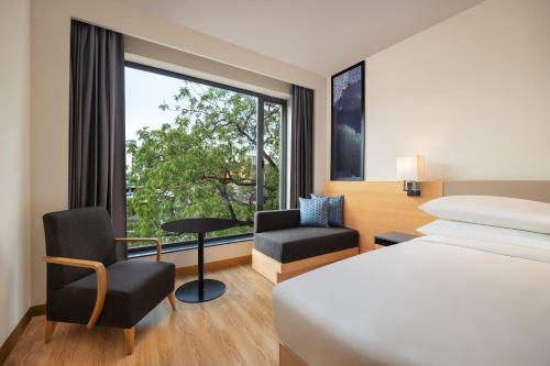 a hotel room with a bed and a window at Fairfield by Marriott Jaipur in Jaipur