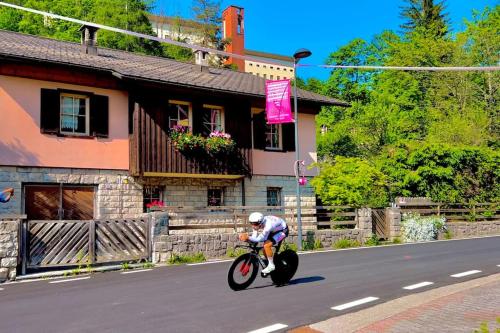a man riding a motorcycle down the street at Lussuoso Chalet in centro a 4 min a piedi dalle piste da sci in Tarvisio