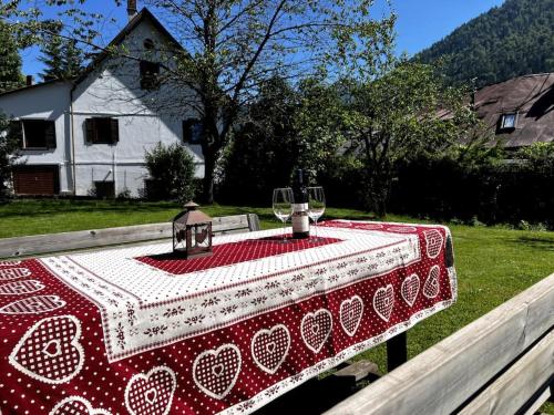 a table with a red and white table cloth on it at Lussuoso Chalet in centro a 4 min a piedi dalle piste da sci in Tarvisio