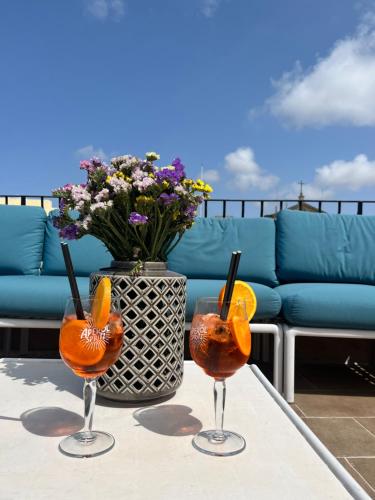 two cocktails on a table with a vase of flowers at My Travel House in Rabat