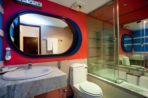 a bathroom with a toilet and a sink and a mirror at Resort Atlantis 