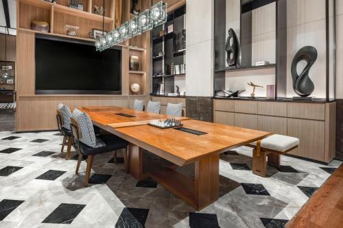 a dining room with a large wooden table and chairs at Four Points by Sheraton Guangzhou, Baiyun in Guangzhou