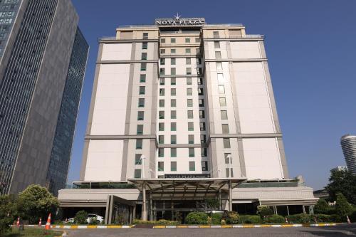 a white building with a sign on top of it at Nova Plaza Prime Hotel-Free Shuttle to Taksim Square in Istanbul