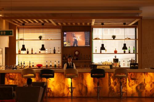 a man sitting at a bar in a restaurant at Sundance Hotel Istanbul in Istanbul