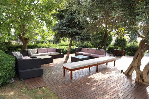 a patio with couches and a bench and trees at Sundance Hotel Istanbul in Istanbul