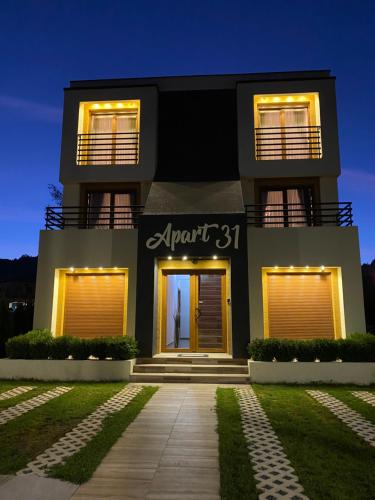 a black house with lights in front of it at Apart 31 in Cetinje