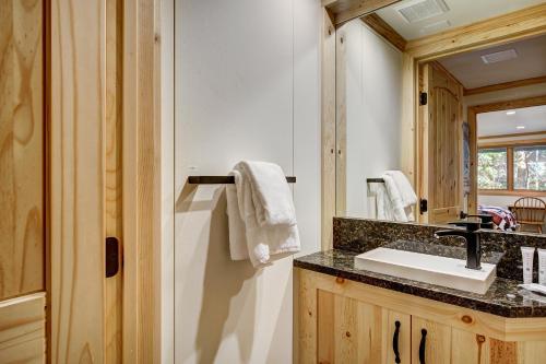 a bathroom with a sink and a mirror at Two Bedroom Condo with Parking, Pool, Hot Tub - Steps to Main Street in Breckenridge