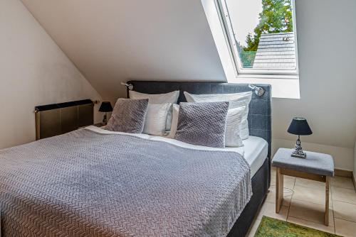 a bedroom with a bed and a large window at Apartment#1 in Kerpen