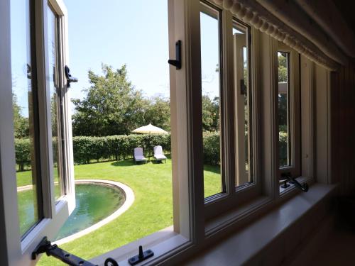 a window with a view of a pool and a yard at Utopia in Harleston