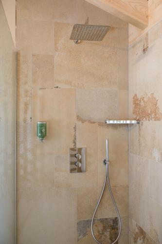 a shower with a glass door in a bathroom at Feriendorf Waidlerland in Mauth