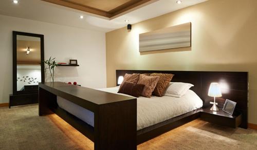 a bedroom with a large bed with a desk at Mozar Street in Mainit