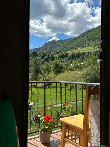 a room with a balcony with a view of the mountains at Bala's House in Mestia