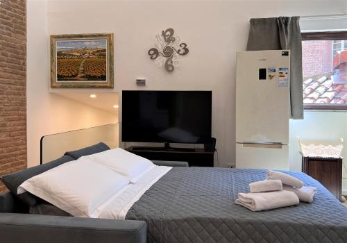a bedroom with a bed with towels on it at Il Terrazzo di Tolomei in Siena