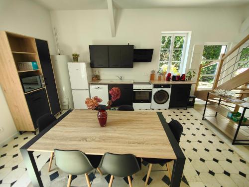 a kitchen with a table and chairs in a room at La maison du bien-être 