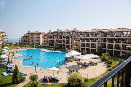 a large swimming pool with people in a resort at Kaliakria Resort in Topola