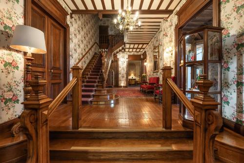 a hallway of a home with a staircase and a stair case at Grand Hôtel Des Templiers, Piscine & Spa in Reims