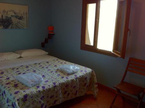 a bedroom with a bed and a window at Mamma Etna in Pedara