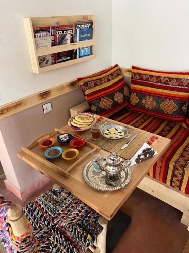 a room with a table with a tea set on it at Tazart Lodge in Marrakech