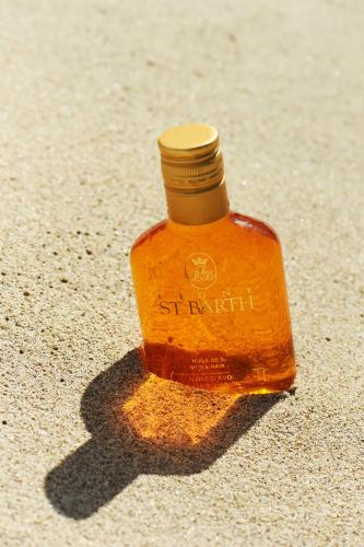 a bottle of honey sitting on the sand at Constantinos the Great Beach Hotel in Protaras