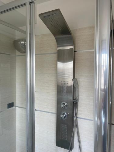 a shower with a glass door in a bathroom at Exotic Home San Paolo Roma in Rome