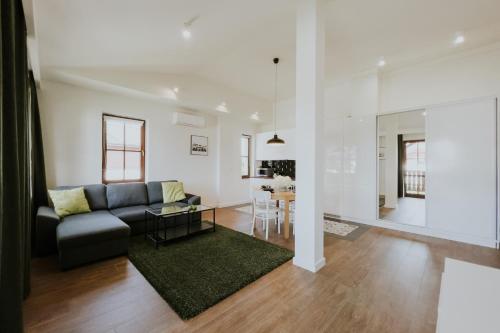 a living room with a couch and a table at Aura Medical SPA Nałęczów in Nałęczów