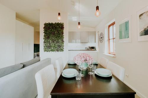 a kitchen and dining room with a table and chairs at Aura Medical SPA Nałęczów in Nałęczów