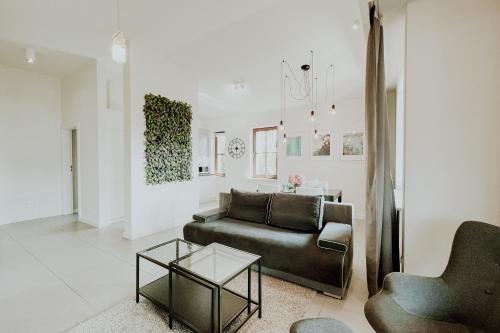 a living room with a couch and a table at Aura Medical SPA Nałęczów in Nałęczów