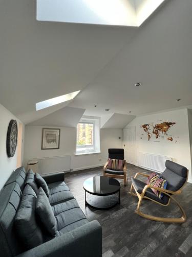 een woonkamer met een bank en een tafel bij Very Central, Charlotte Square, near the Castle in Edinburgh