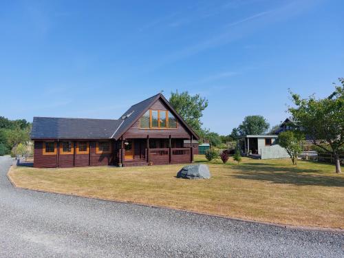 a large wooden house on the side of a road at Eirianfa in Menai Bridge