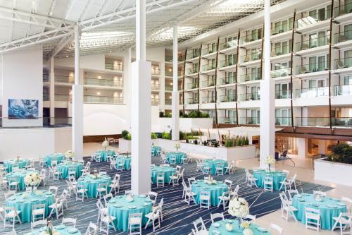 a rendering of therium of a building with blue tables and chairs at Newport Marriott Hotel & Spa in Newport